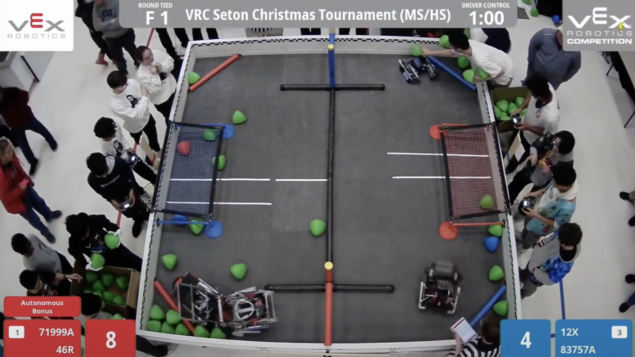Overhead view of VRC match at the 1-minute mark showing scattered robots and Triballs